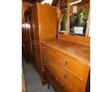 A 1930s oak bedroom suite, comprising wardrobe, dressing table chest and a further three drawer oak chest.  (4)