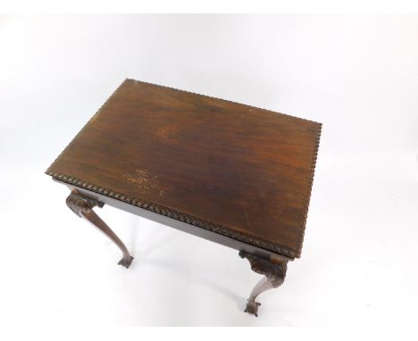 A Georgian style fold over card table, with a green baize interior, raised on leaf carved cabriole legs, on ball and claw fee