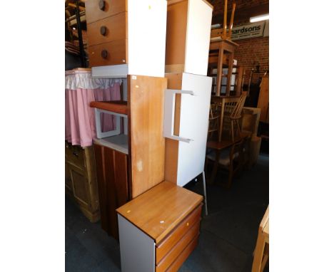 A late 20thC teak and white melamine bedroom suite, comprising wardrobe, bedside cabinets, dressing table and drawers. (7)