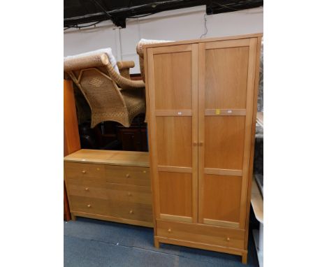 An oak and beech part bedroom suite, comprising two door wardrobe and a matching chest of six drawers.