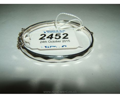 A child's Silver Bangle with faceted decoration