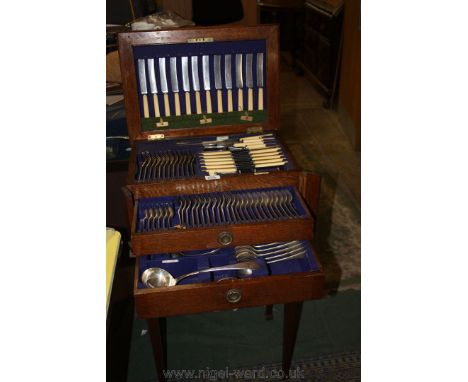 An Oak cutlery Cabinet complete with a set of Walker and Hall Ltd cutlery, comprising Game Carvers, Beef Carvers, Steel, twel