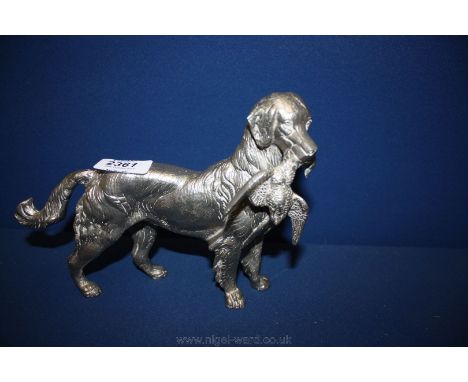 A metal figure of a hunting dog with a bird in his mouth