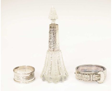 Victorian silver snap bangle, Birmingham 1884, a silver mounted perfume bottle, Birmingham 1901, and a silver napkin ring, Bi