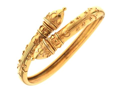 Yellow metal hollow torc bangle, with berry and acorn decoration, unmarked, 17.8g approx
