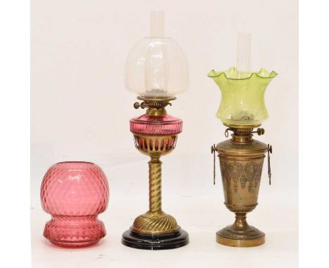 Late Victorian or Edwardian oil lamp, with floriate engraved shade over gilt metal twin-handled body with classical scroll de