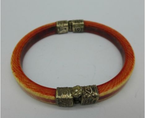 An Indian 19th Century stained ivory and white metal bangle
