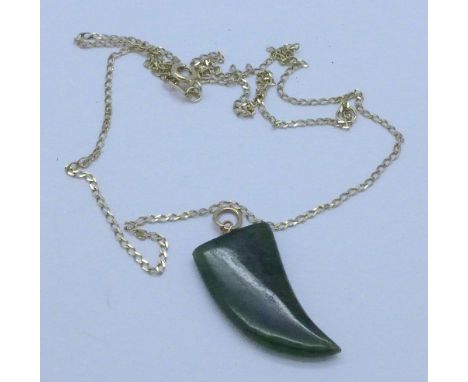 A jade claw pendant on a 9ct gold chain, weight of chain 1g