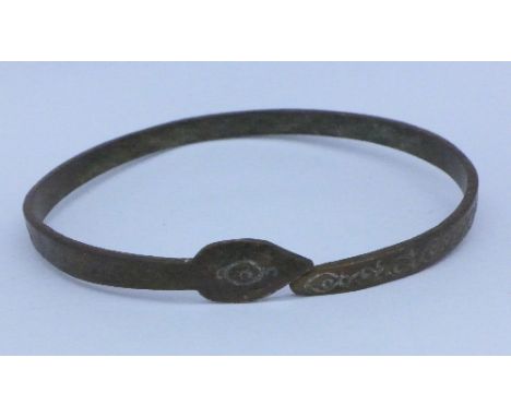 An early copper alloy serpent bangle