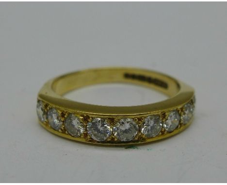 An 18ct gold ring set with nine diamonds, approximately 1.10 carat diamond weight, 4.4g, O