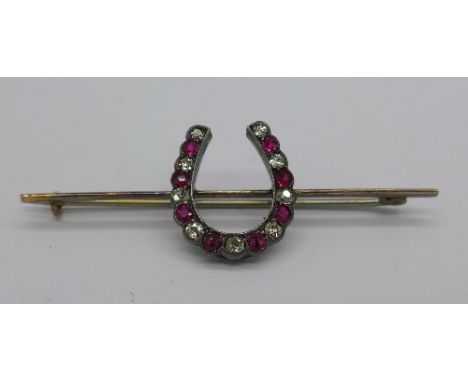 A diamond and ruby set horseshoe brooch, height 17mm