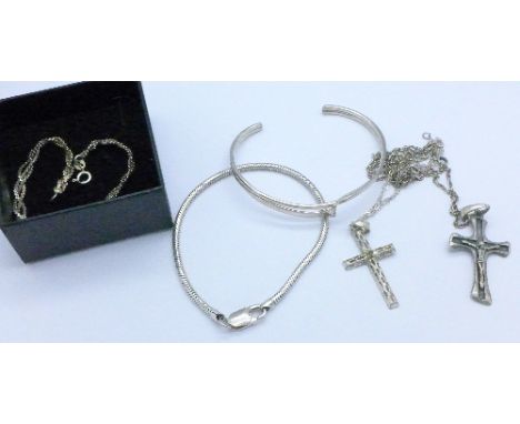 Two silver cross pendants and chains, two silver bracelets and a silver bangle