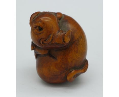A carved warthog netsuke