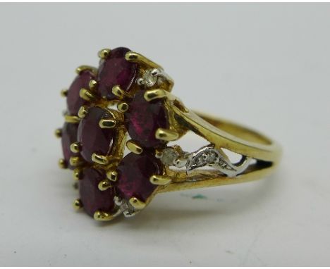A 9ct gold, ruby and diamond cluster, 4.9g, N