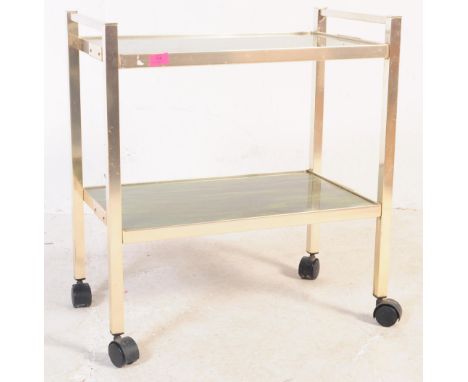 A vintage 20th century circa 1940s butlers / serving / cocktail drinks trolley. Of rectangular form with pull push handles to