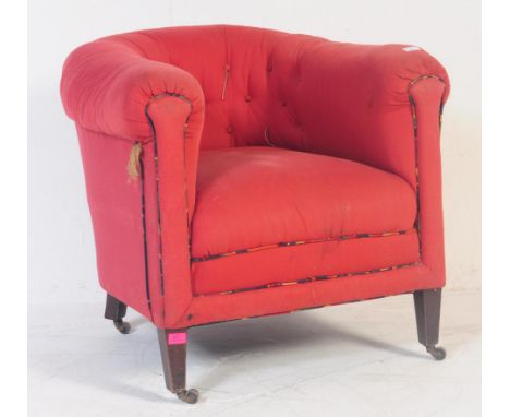 Edwardian / 1920s button back lounge tub armchair. Having a curved backrest into elbow rests. With over stuffed cushioned sea