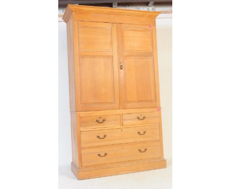 A Victorian 19th century ash / oak chest of drawers / linen press.&nbsp; Raised on a plinth base with a double door linen pre