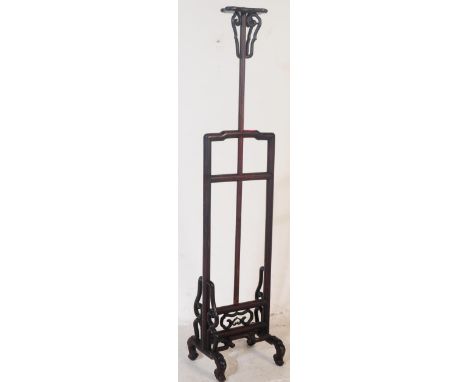 A vintage 20th century carved Chinese hardwood floor standing lamp. Having a central column with platform to top, flanked by 