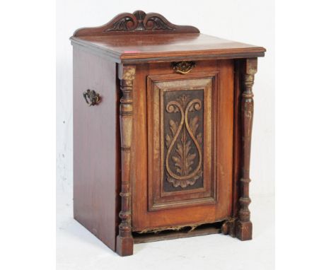 A Victorian 19th century mahogany Art Nouveau coal purdonium. Pedestal form with gallery top over hinged fall front coal purd