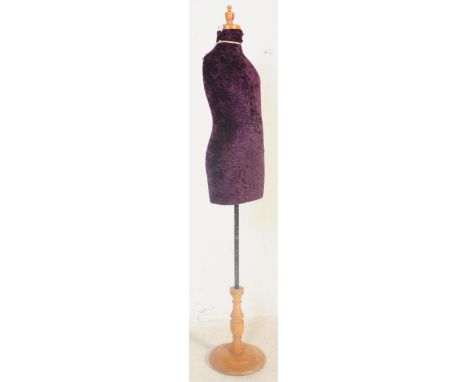 A vintage 20th century haberdashery tailors female mannequin having a purple crushed velvet body over turned wood stand. Meas