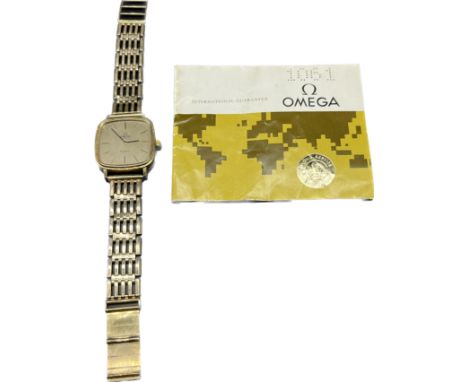 Vintage Omega De Ville Quartz watch fitted with a 9ct gold gate bracelet. Comes with booklet. 