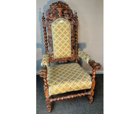 19th century Highly carved Jacobean style arm chair. Carved finial top section, flanked by two barley twist column supports, 