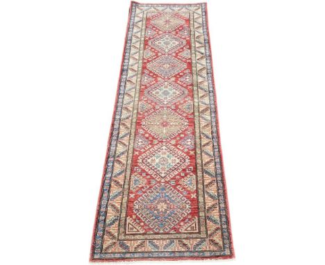 A Large Persian style hall runner rug. [262x84cm] 