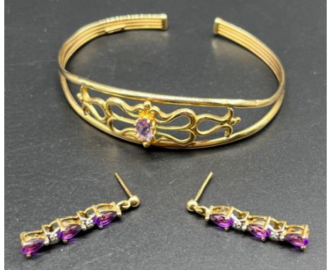 9ct yellow gold bangle set with a single Amethyst stone, together with a pair of 9ct gold amethyst and diamond stone drop ear