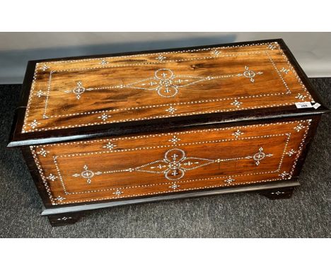 Indian inspired hardwood trunk; detailed with mother of pearl design and finished with brass swing handles. [39x78x34.5cm] 