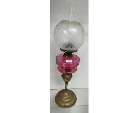 19th century Brass and cranberry glass paraffin lamp; globe shade with etched bird and butterfly design, Cranberry glass body