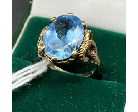 9ct yellow gold ring set with a large oval cut blue gem stone. [6.56grams] [Ring size K] 