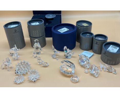 A Collection of Swarovski crystal sculptures; Large clam and pearl and one smaller one, Three various sized swans, Two varyin
