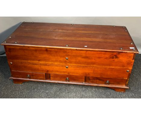 Large Indian inspired wooden trunk; Brass stud trims, Brass swing handles and fitted with three smaller drawers to the base. 