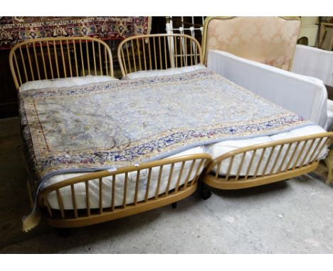 Matching pair of Ercol single beds, boat shaped, on castors, with mattresses (as new) (2)