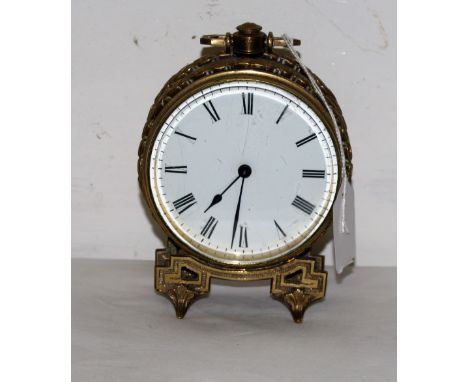 French Brass Framed Mantle Clock, with a white dial and carrying handle, raised on brass feet, 4” dia, 5.5”h (not working)