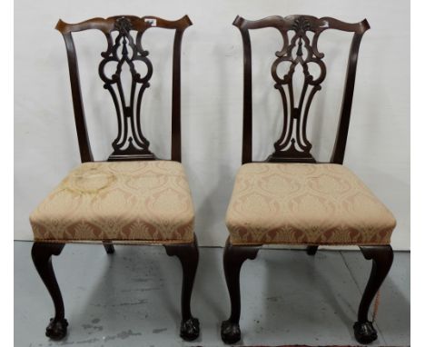 Matching pair of Mahogany side chairs, Chippendale style with ball and claw feet, pink padded seats