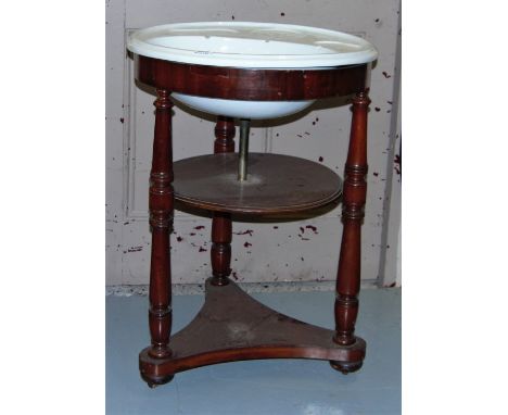 White ceramic circular sink with soap wells, in its original mahogany stand, 23”dia