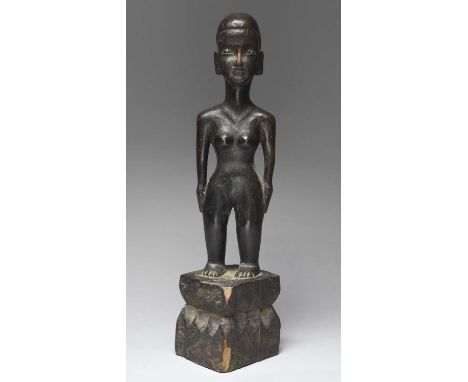 A Ifugao female bulul figureLuzon Island, Philippinesstanding with a long coiffure and inset ceramic pupils, raised on a wais