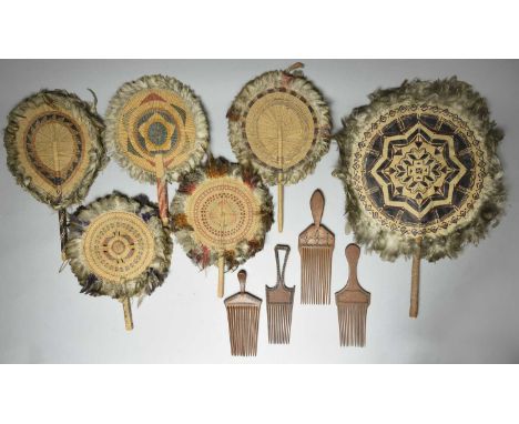 Six Fiji / Tonga fansnatural and dyed fibre and feathers, the largest with a painted tapa centre,39cm diameter,and four Solom