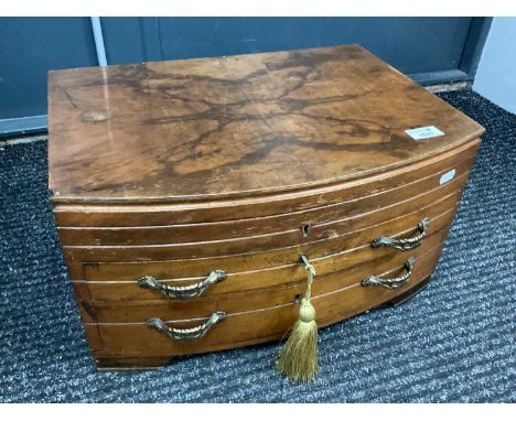 A Mid-1900s Walnut Bow Front Cutlery Cabinet Converted to a Collectors Box, opening top and two drawers plus key (some conten
