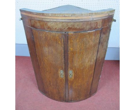 A XIX Century Oak and Mahogany Bow Fronted Corner Cupboard, with three internal shelves, 96cm high.