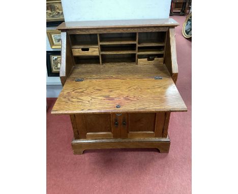 Oak Bureau, with a panelled fall front, fitted interior, single drawer over twin cupboard doors on bracket feet 85cm wide.