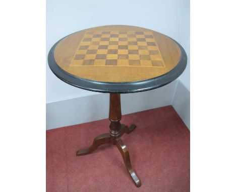 A XIX Century Walnut Games Table, with circular inlaid chess board top and moulded edge raised on a turned pedestal and cabri
