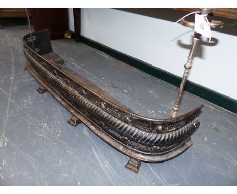A REGENCY POLISHED STEEL PIERCED D FORM FIRE FENDER AND A SET OF THREE FIRE TOOLS OF THE SAME PERIOD. 123CM WIDE 