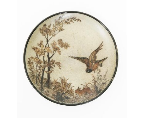 A Martin Brothers stoneware wall plate by Robert Wallace Martin, dated 1887, incised with a bird flying past a smaller rabbit