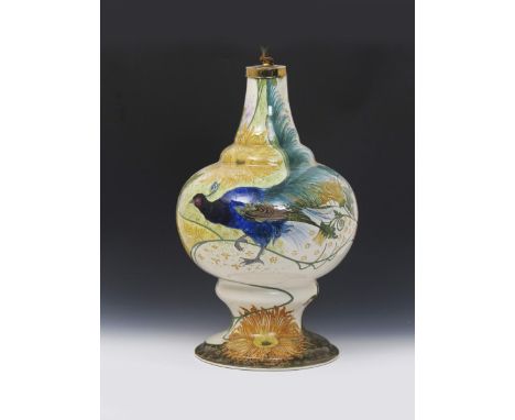A large Art Nouveau Gouda Pottery vase, painted with an exotic blue bird with long tail, amidst panels of stylised flowers an
