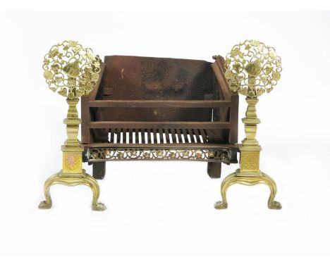 A Longden & Co brass and wrought iron Old English fire basket, the tapering columns on flaring feet, with cast, pierced Medie
