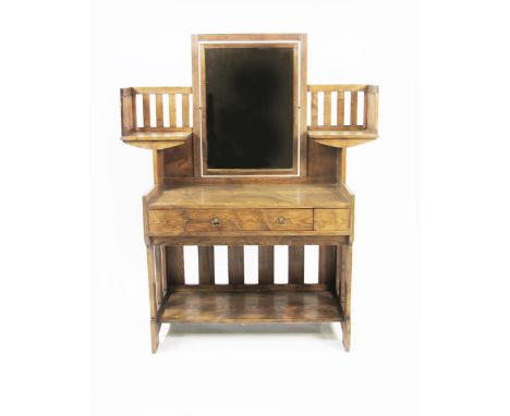 A Liberty & Co oak dressing table designed by Leonard Wyburd, the shelved slat-back with rectangular mirror, above central dr