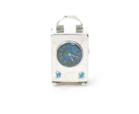 A Liberty & Co Cymric silver, enamel and turquoise clock,  rectangular form on ball feet, with hinged back and handle, set wi