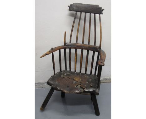 REMARKABLE WELSH PRIMITIVE STICK BACKED ELBOW CHAIR, principally in elm and ash, having comb back, wrap around arms and solid